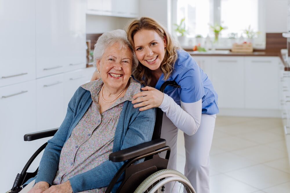A senior woman in a wheelchair and her caregiver at the best skilled nursing in San Diego
