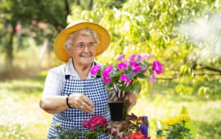 A senior woman cares for flowers on a spring day