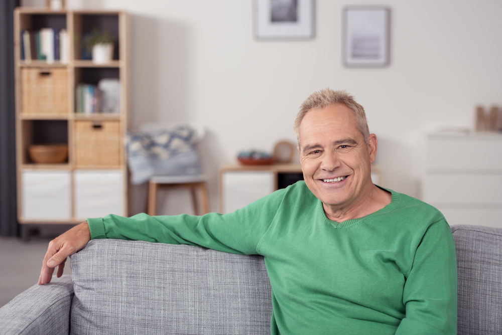 Smiling senior man on couch.