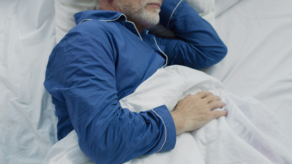 Male asleep in senior living san diego.