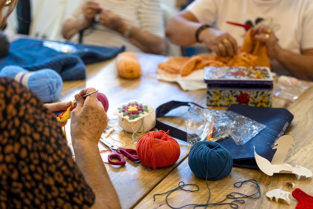 Elderly women knitting as a group activity at a retirement community San Diego