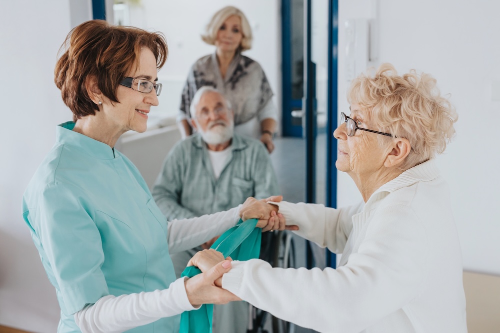 Senior woman getting help from nurse at a skilled nursing community